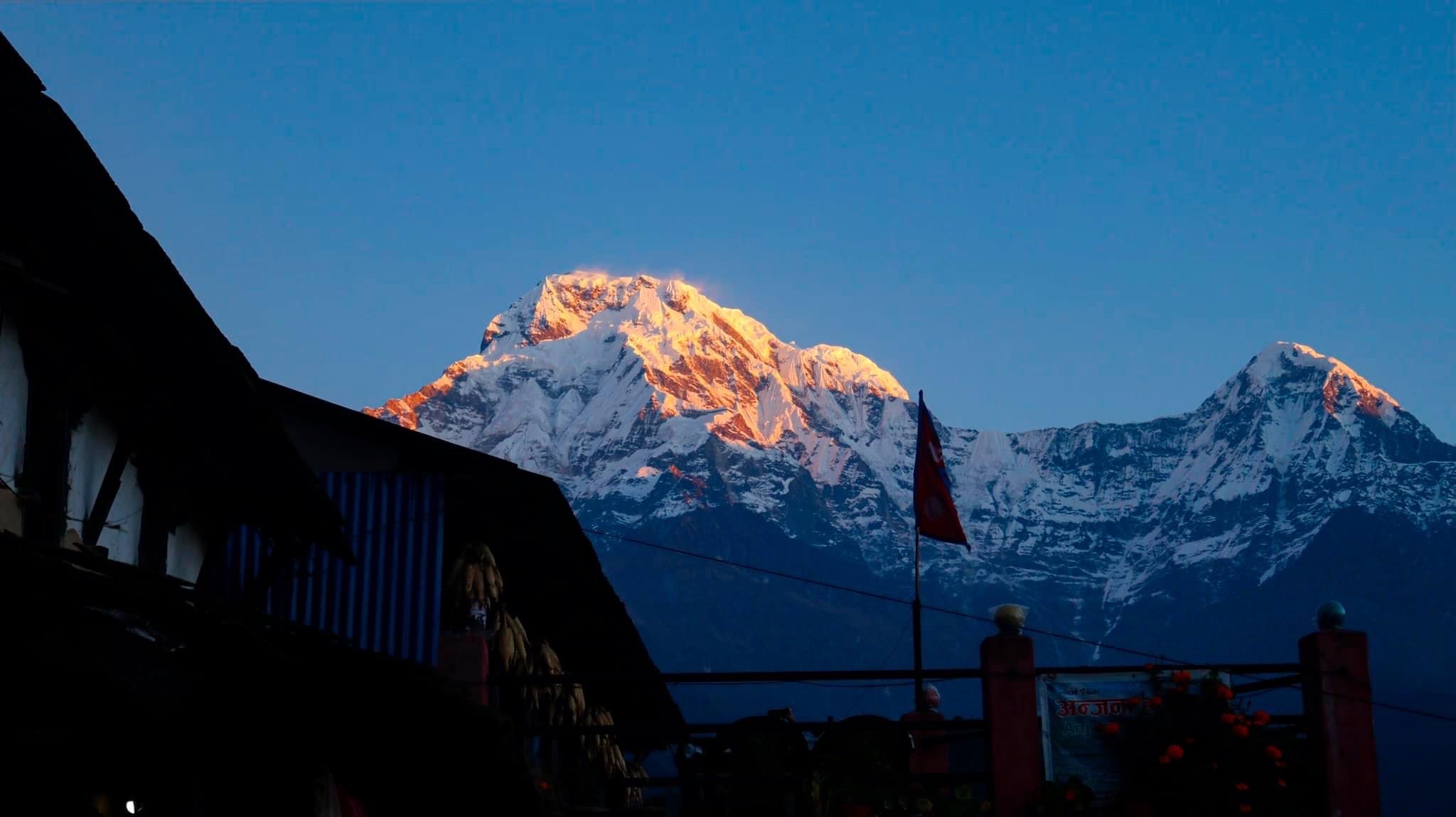 Mountain sunrise landscape — golden light on snow-capped Himalayan peaks at dawn