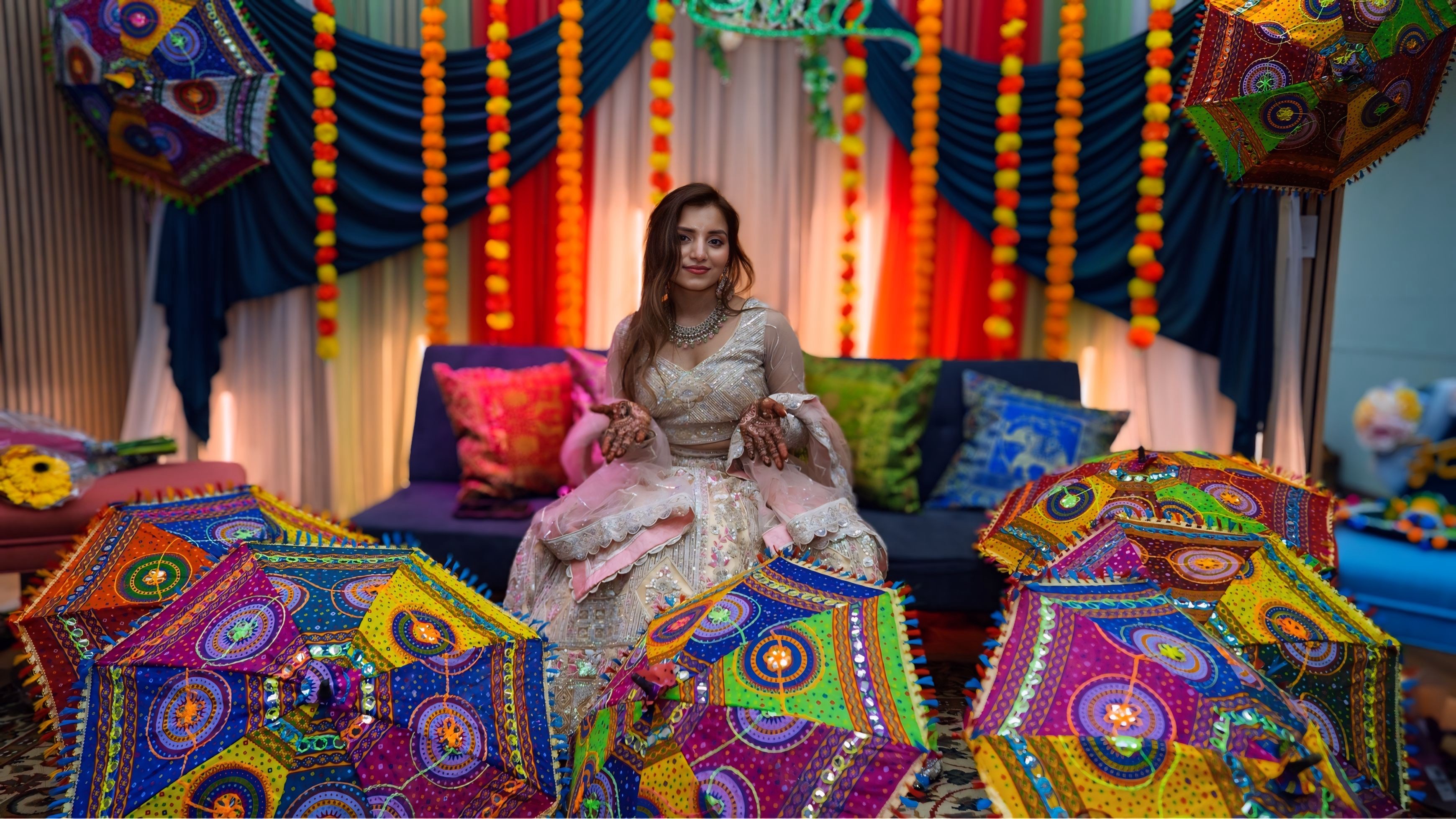 Bride portrait with colorful Rajasthani umbrellas at mehndi ceremony