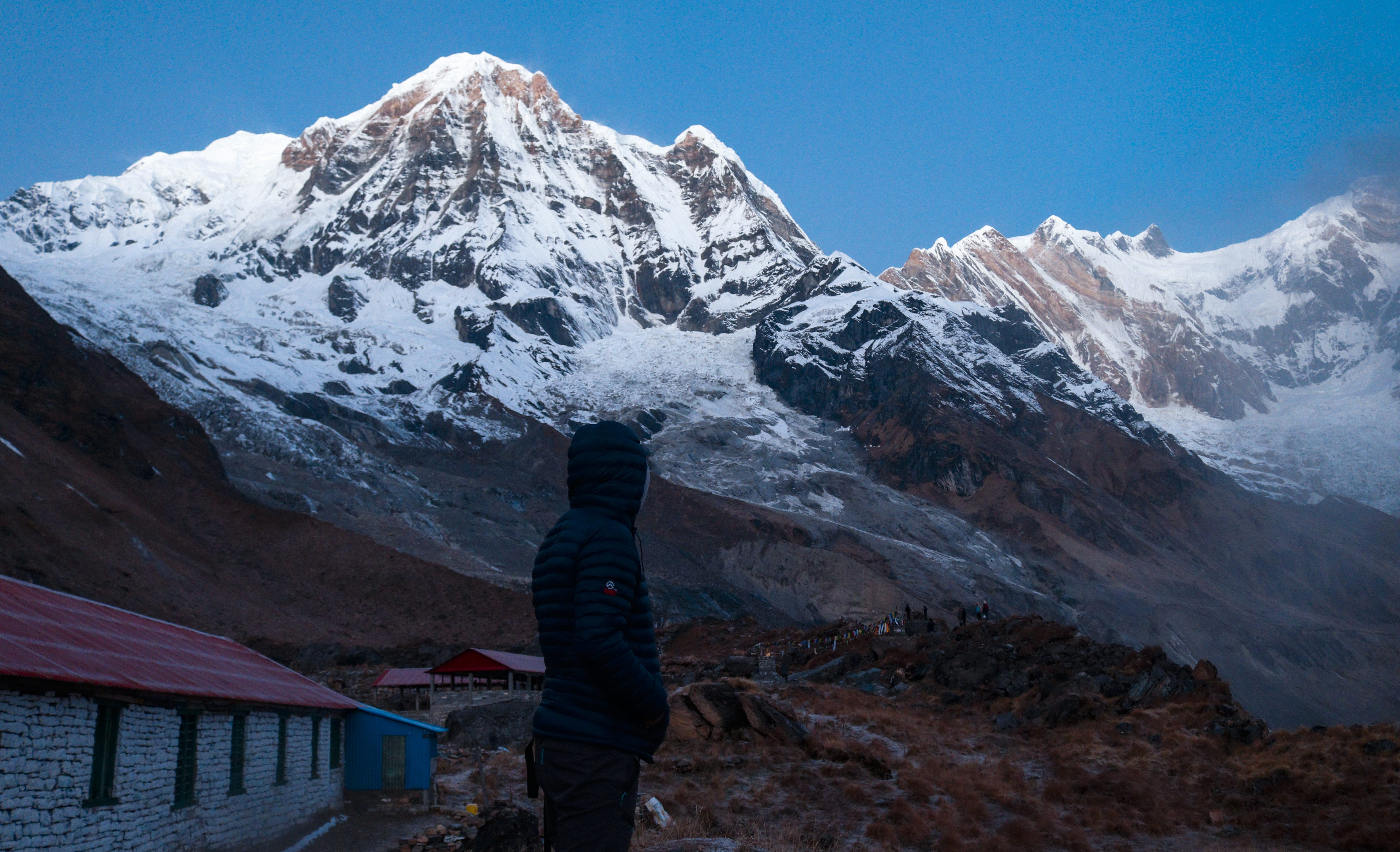 Annapurna base camp — silhouette of a person gazing at the majestic Himalayan mountain range